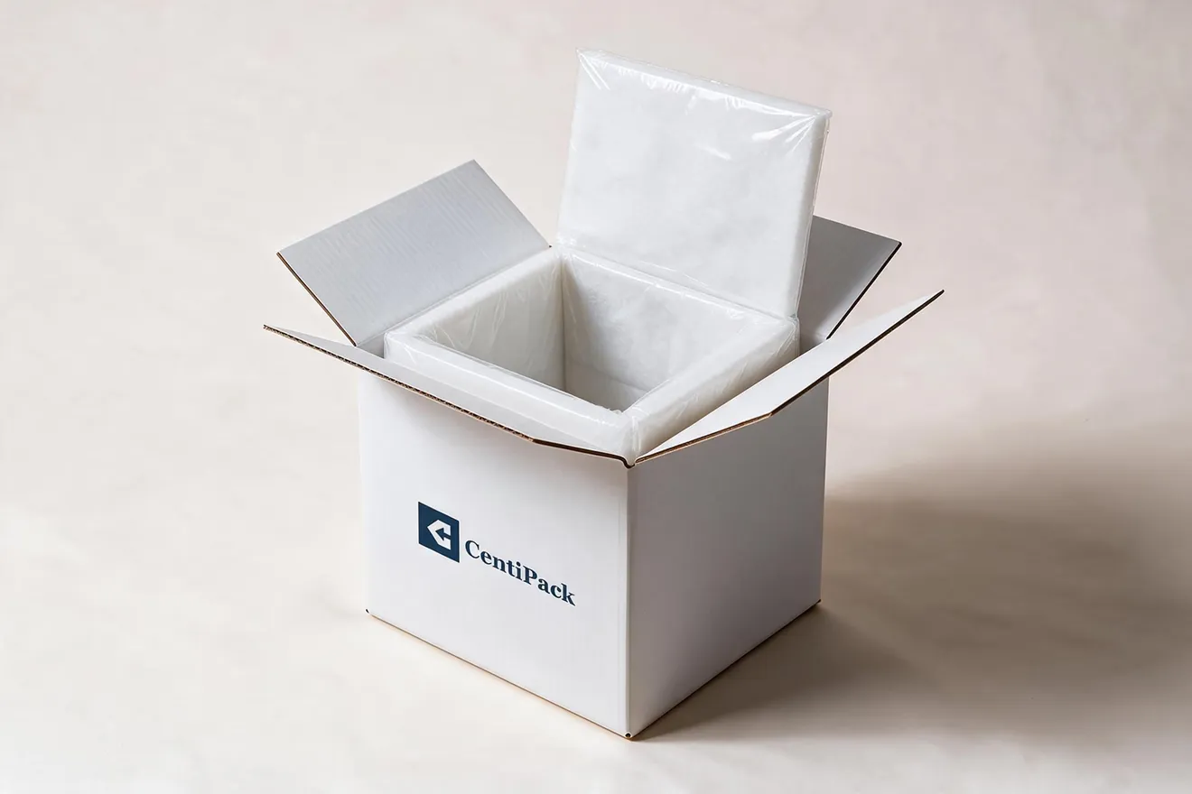 A white liner under clear film fitted inside an open white CentiPack carton, its top panel folded back.