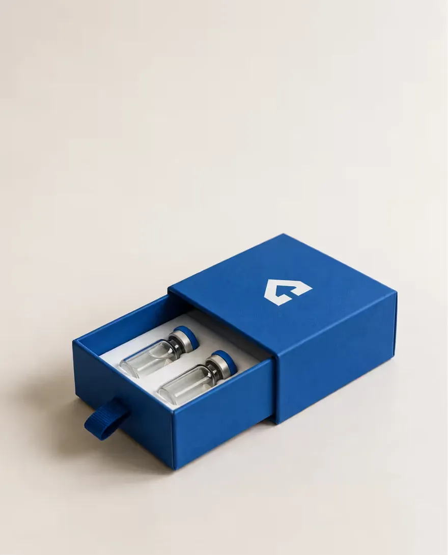 A blue drawer box slid open to show two vials in a fitted insert.